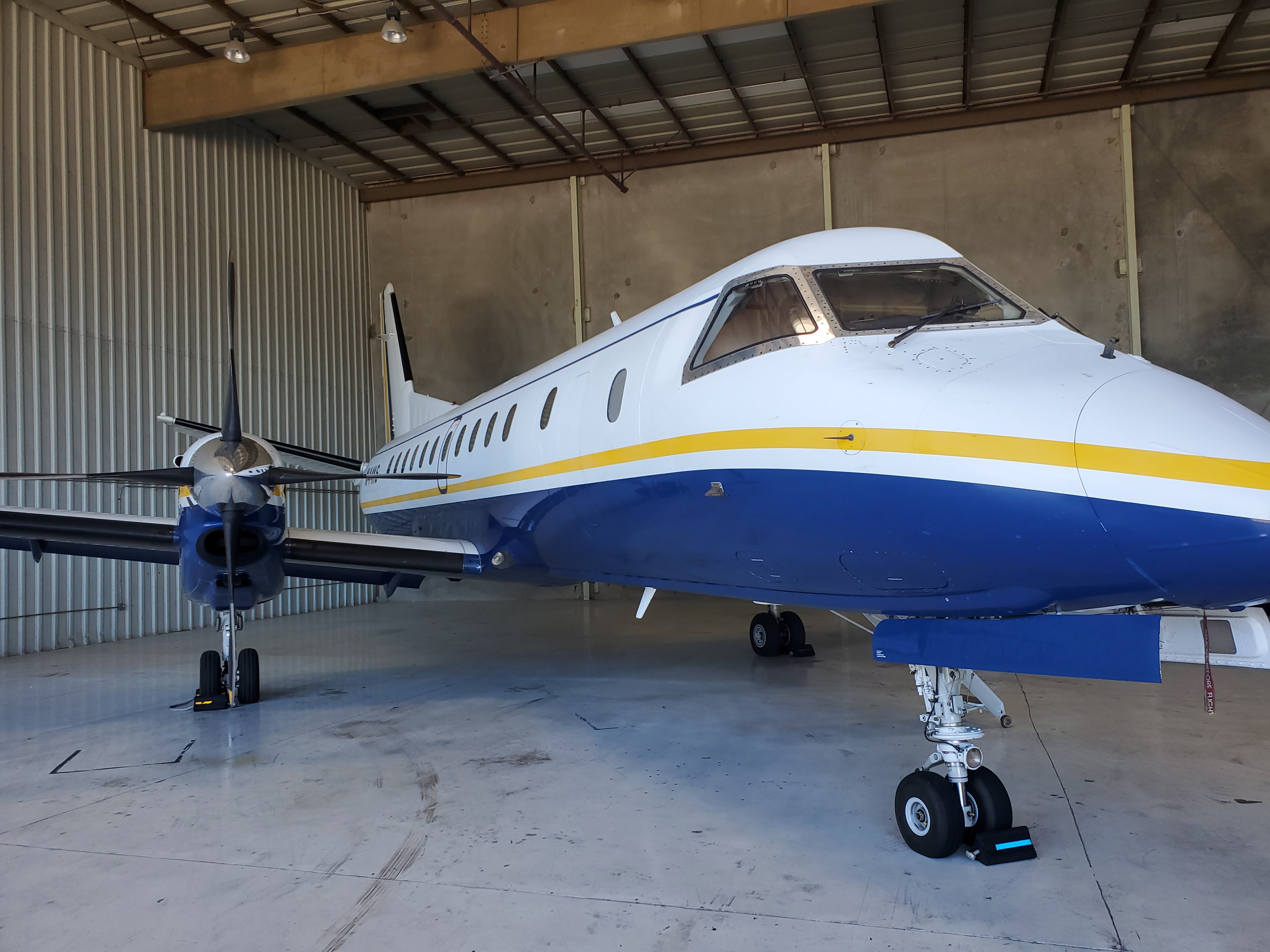 Twin-engine aircraft in a hangar, ready for Zenith Avionics service