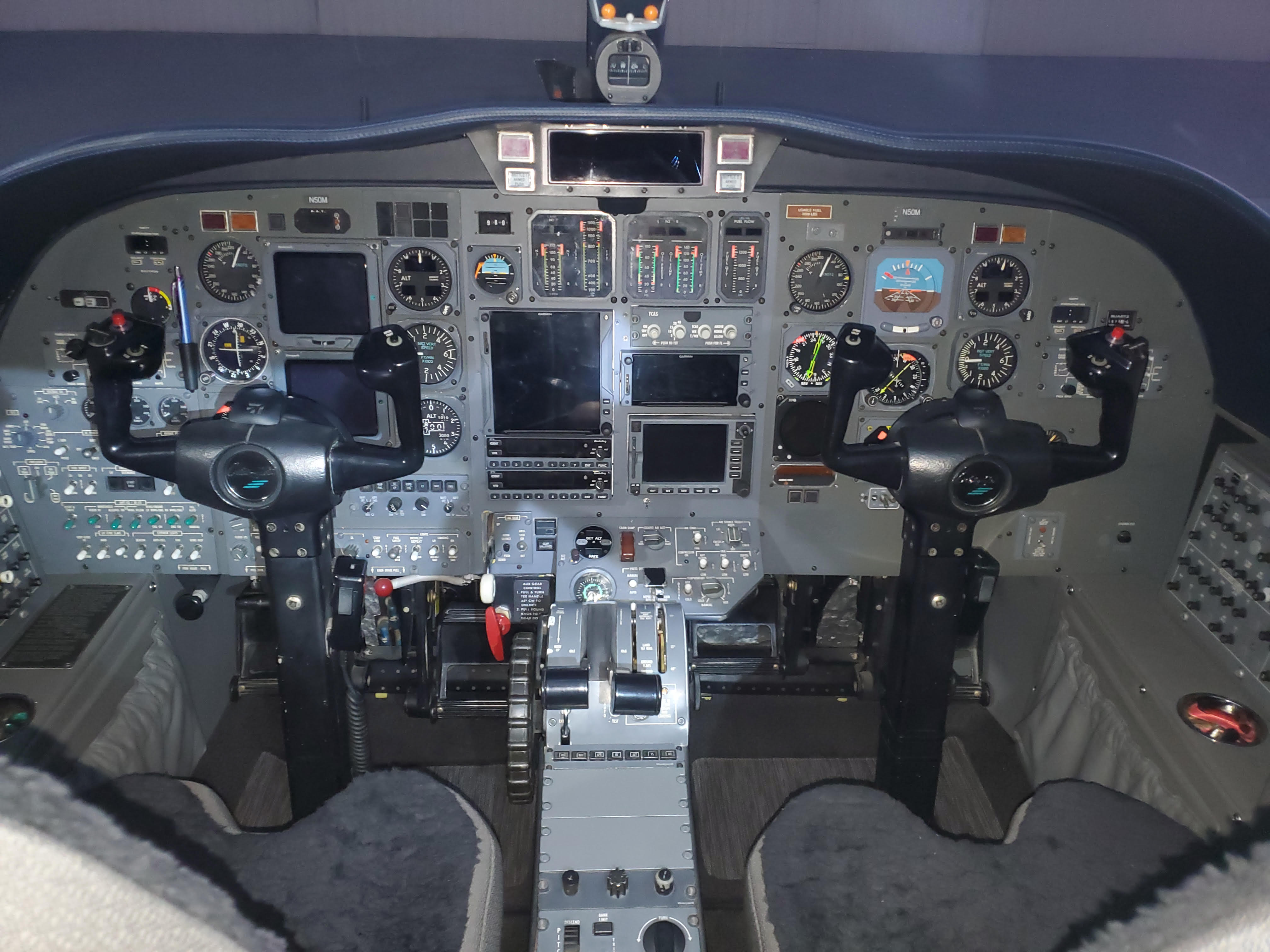 Detailed view of a modern aircraft cockpit instrument panel, showcasing avionics work