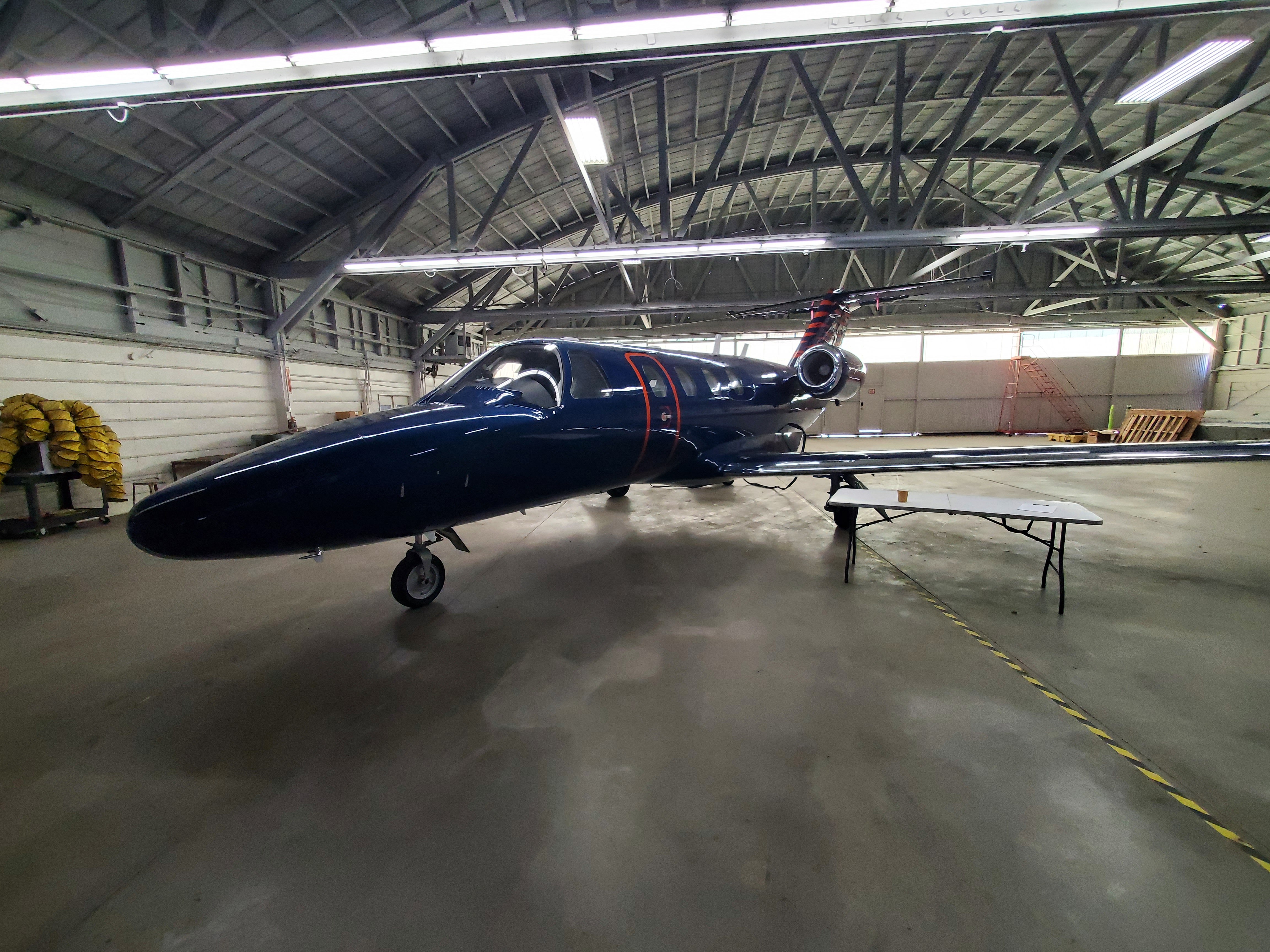 Sleek business jet in hangar, representing Zenith Avionics' professional services